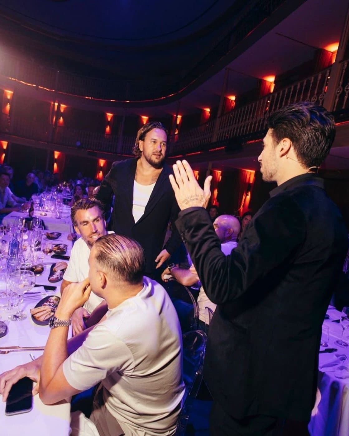 Lion among guests at a gala dinner in a theatre hall